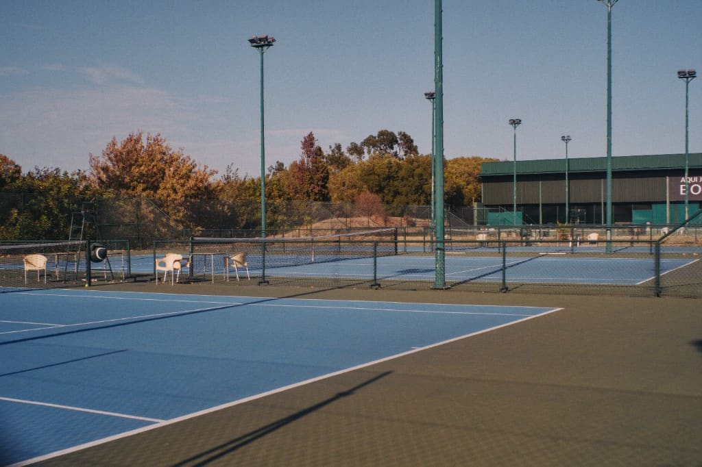 Outdoor tennis courts at a multi-court racquet sports club